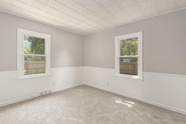488 Roberts St, Muskegon, MI 49442 - carpeted empty room with an ornate ceiling, ornamental molding, and baseboards