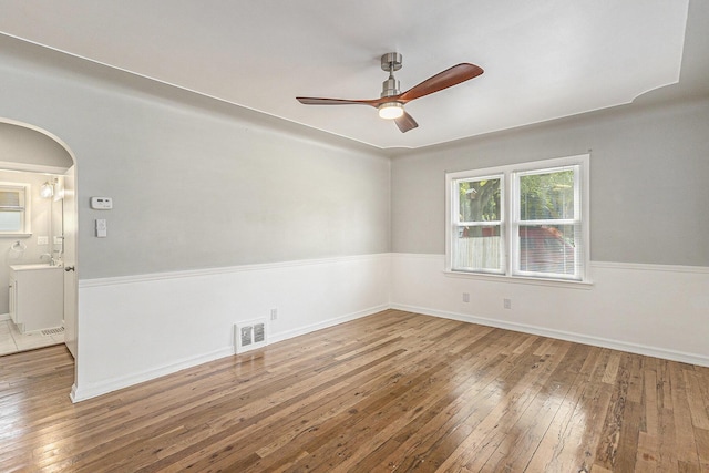 488 Roberts St, Muskegon, MI 49442 - spare room with a ceiling fan, hardwood / wood-style flooring, and arched walkways