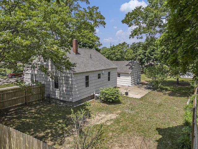 488 Roberts St, Muskegon, MI 49442 - rear view of property with a shingled roof, a patio area, central AC unit, and a chimney
