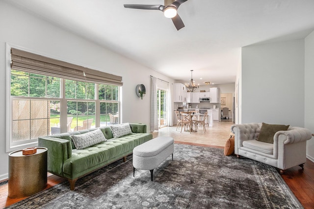 4844 Ontario Dr, Buchanan, MI 49107 - living area featuring a chandelier, ceiling fan, and light wood-style flooring