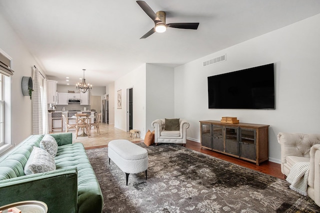 4844 Ontario Dr, Buchanan, MI 49107 - living room with a chandelier, a ceiling fan, and light wood finished floors