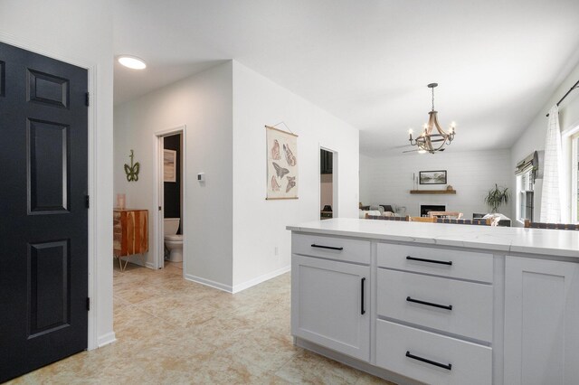 4844 Ontario Dr, Buchanan, MI 49107 - kitchen with a chandelier, light countertops, white cabinetry, hanging light fixtures, and open floor plan