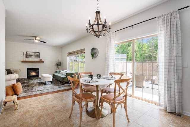 4844 Ontario Dr, Buchanan, MI 49107 - dining room featuring a chandelier, a glass covered fireplace, ceiling fan, and light tile patterned floors