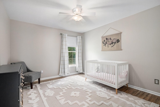 4844 Ontario Dr, Buchanan, MI 49107 - bedroom featuring wood finished floors, a crib, and a ceiling fan