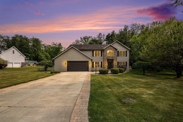 4844 Ontario Dr, Buchanan, MI 49107 - traditional-style home featuring concrete driveway, a lawn, stone siding, and a garage