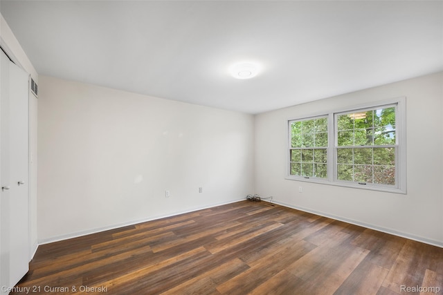 29801 Deer Run, Farmington Hills, MI 48331 - unfurnished bedroom featuring dark wood-style floors, a closet, and baseboards