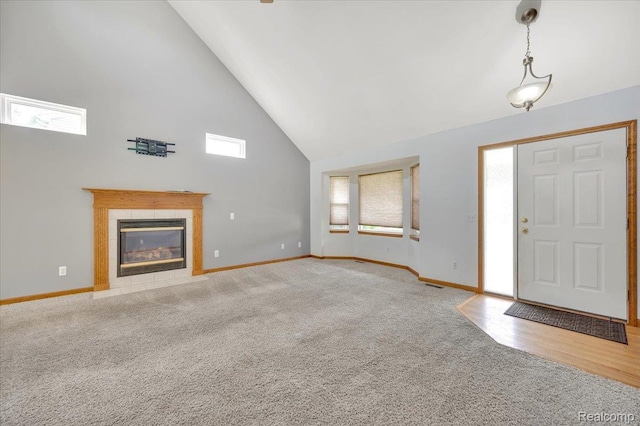 38 Melvin J Ct, Oxford, MI 48371 - foyer with high vaulted ceiling, carpet flooring, baseboards, and a tile fireplace