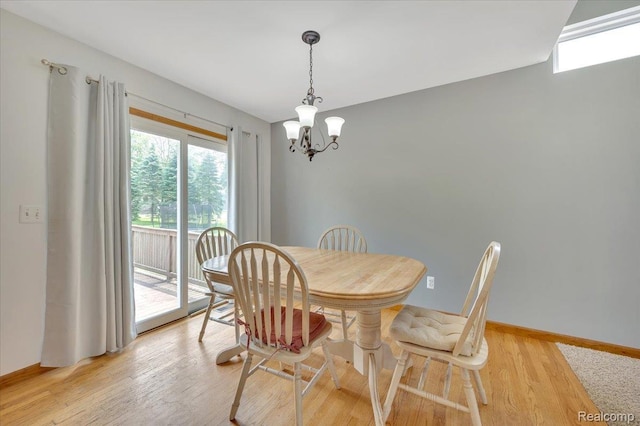 38 Melvin J Ct, Oxford, MI 48371 - dining area featuring a chandelier, light wood-style flooring, and baseboards