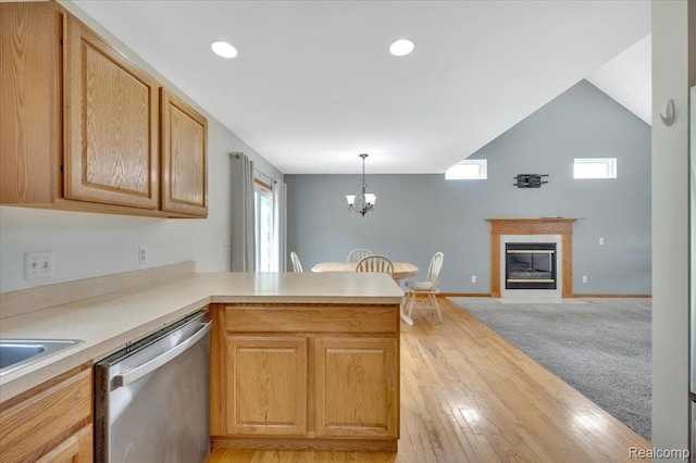38 Melvin J Ct, Oxford, MI 48371 - kitchen with stainless steel dishwasher, a peninsula, a chandelier, light countertops, and light wood-style flooring