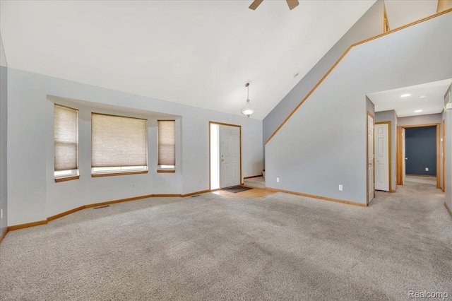 38 Melvin J Ct, Oxford, MI 48371 - unfurnished living room featuring light colored carpet, baseboards, ceiling fan, and high vaulted ceiling