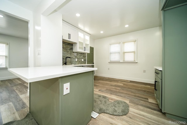 16240 Washburn St, Detroit, MI 48221 - kitchen featuring light countertops, tasteful backsplash, wood finished floors, a peninsula, and recessed lighting