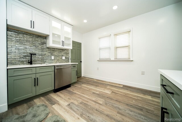 16240 Washburn St, Detroit, MI 48221 - kitchen with dishwasher, green cabinetry, light countertops, backsplash, and baseboards