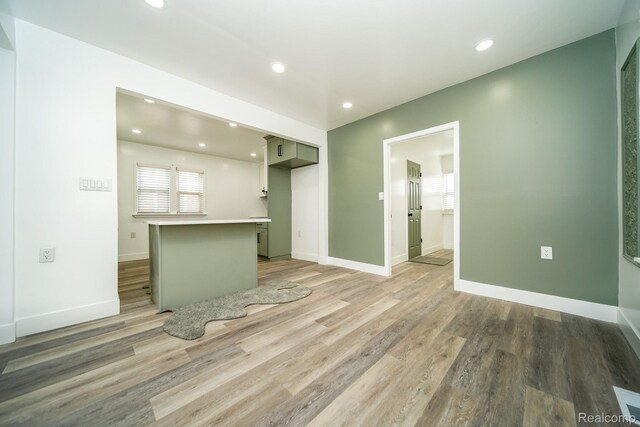 16240 Washburn St, Detroit, MI 48221 - kitchen featuring light wood-type flooring, recessed lighting, baseboards, light countertops, and a center island