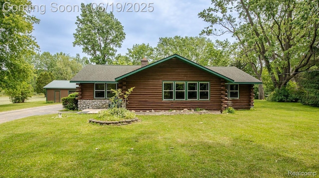 5180 Hillsboro Rd, Davisburg, MI 48350 - log-style house featuring log siding, a chimney, a front yard, and driveway
