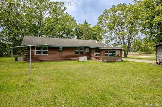 5180 Hillsboro Rd, Davisburg, MI 48350 - rear view of property with a lawn, log exterior, driveway, and a shingled roof