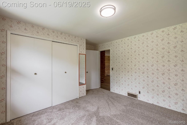 5180 Hillsboro Rd, Davisburg, MI 48350 - unfurnished bedroom with wallpapered walls, carpet flooring, and a closet