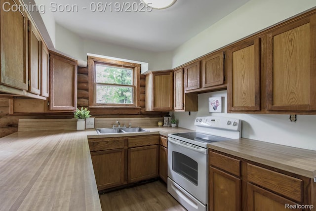5180 Hillsboro Rd, Davisburg, MI 48350 - kitchen with white range with electric cooktop, brown cabinetry, wood finished floors, log walls, and butcher block counters
