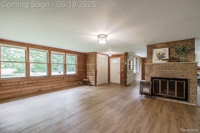 5180 Hillsboro Rd, Davisburg, MI 48350 - unfurnished living room with wood finished floors, plenty of natural light, and a fireplace