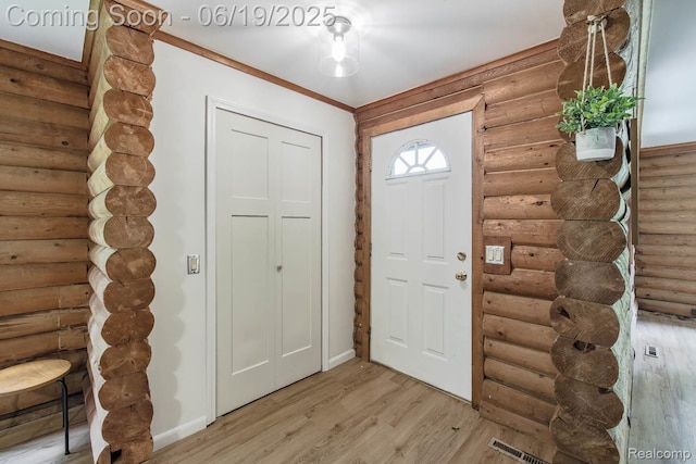 5180 Hillsboro Rd, Davisburg, MI 48350 - foyer entrance featuring log walls and light wood-style flooring