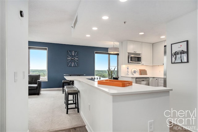 60 Campau Cir NW Unit 2308, Grand Rapids, MI 49503 - kitchen featuring stainless steel appliances, white cabinets, recessed lighting, baseboards, and light countertops