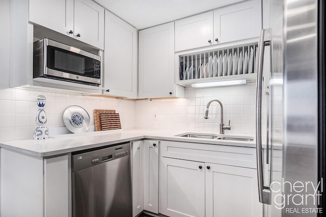 60 Campau Cir NW Unit 2308, Grand Rapids, MI 49503 - kitchen with stainless steel appliances, a sink, backsplash, and light countertops