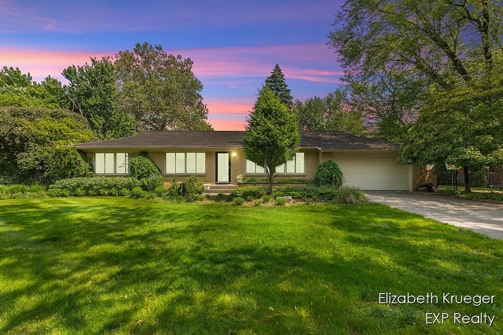 2335 Delange Dr SE, Grand Rapids, MI 49506 - view of front facade with a garage and concrete driveway