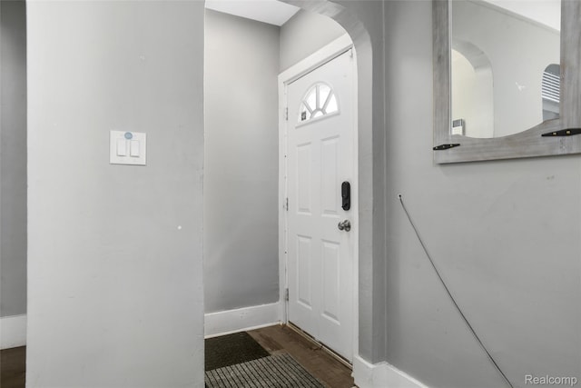 13572 Indiana St, Detroit, MI 48238 - entryway featuring arched walkways, dark wood-type flooring, and baseboards