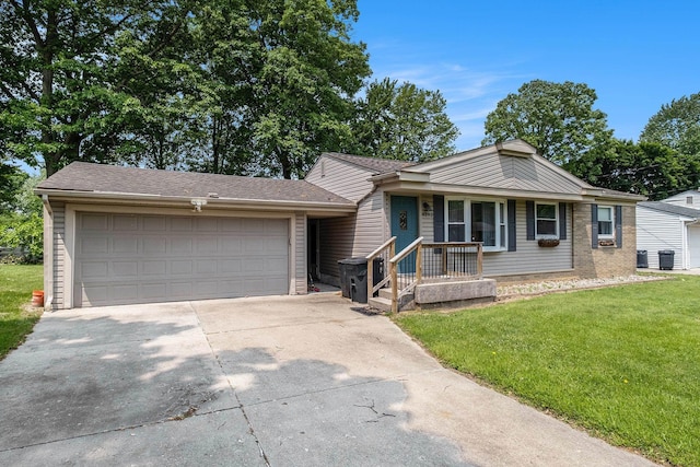 4292 Ashlawn Dr, Flint, MI 48507 - view of front facade featuring concrete driveway, a front yard, and a garage