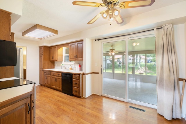 4292 Ashlawn Dr, Flint, MI 48507 - kitchen with dishwasher, ceiling fan, brown cabinets, light countertops, and a sink