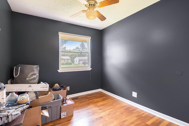 4292 Ashlawn Dr, Flint, MI 48507 - office featuring a ceiling fan, wood finished floors, baseboards, and a textured ceiling