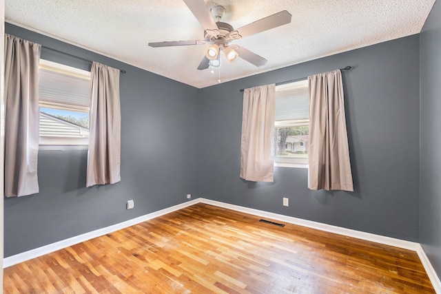 4292 Ashlawn Dr, Flint, MI 48507 - empty room featuring wood finished floors, a ceiling fan, a textured ceiling, and baseboards