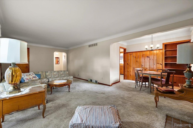 2652 Buckingham Ave, Berkley, MI 48072 - living area with arched walkways, a chandelier, carpet, and baseboards