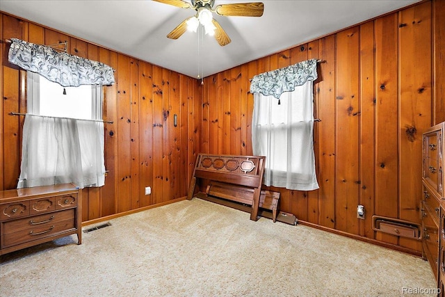 2652 Buckingham Ave, Berkley, MI 48072 - carpeted bedroom with baseboards, a ceiling fan, and wood walls