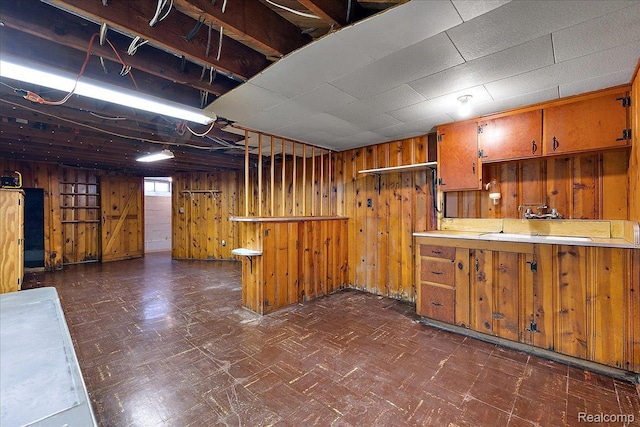 2652 Buckingham Ave, Berkley, MI 48072 - kitchen with wooden walls, brown cabinets, and dark floors