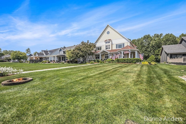 12571 Westwood Ln, Wayland, MI 49348 - view of front of house featuring an outdoor fire pit, a front yard, and a residential view