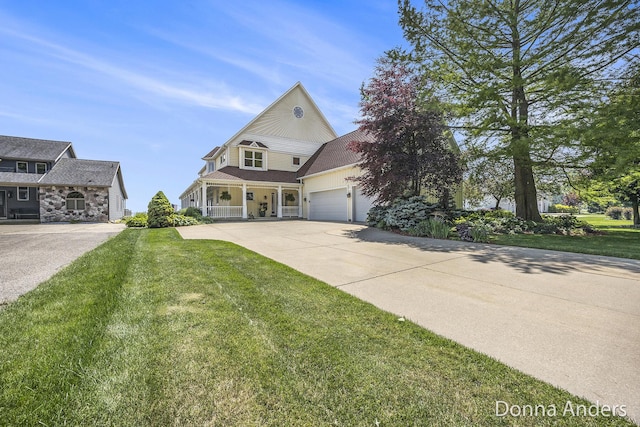 12571 Westwood Ln, Wayland, MI 49348 - view of front of house featuring a front lawn, concrete driveway, covered porch, and an attached garage