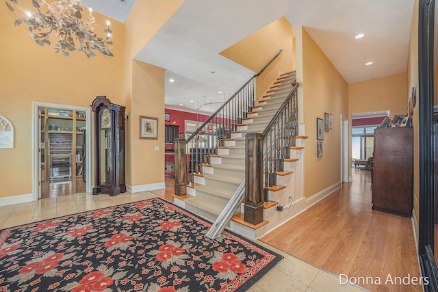 12571 Westwood Ln, Wayland, MI 49348 - tiled entrance foyer with a towering ceiling, stairway, recessed lighting, and a chandelier
