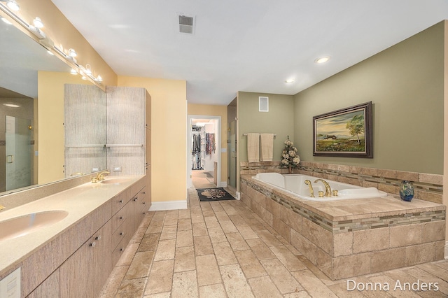 12571 Westwood Ln, Wayland, MI 49348 - full bathroom featuring a bath, double vanity, and recessed lighting
