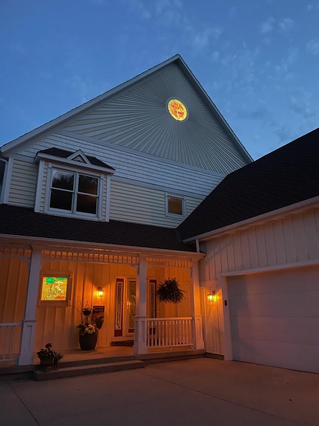 12571 Westwood Ln, Wayland, MI 49348 - view of front of house with covered porch, board and batten siding, concrete driveway, an attached garage, and a shingled roof