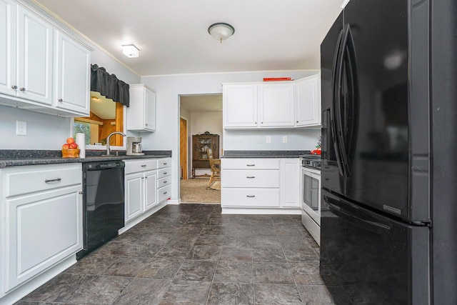 518 Hill Rd, Marshall, MI 49068 - kitchen with black appliances, dark countertops, white cabinetry, and dark stone finish floors