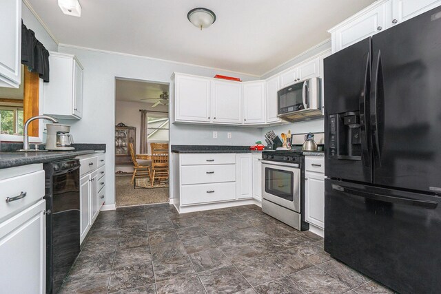 518 Hill Rd, Marshall, MI 49068 - kitchen featuring black appliances, dark countertops, white cabinetry, ceiling fan, and stone finish flooring