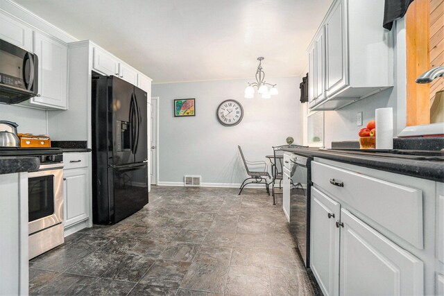 518 Hill Rd, Marshall, MI 49068 - kitchen with black appliances, dark countertops, dark stone finish flooring, white cabinetry, and a chandelier
