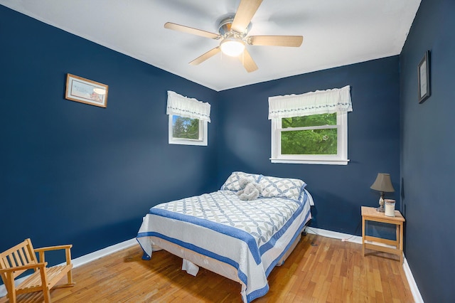 518 Hill Rd, Marshall, MI 49068 - bedroom with multiple windows, baseboards, hardwood / wood-style flooring, and ceiling fan