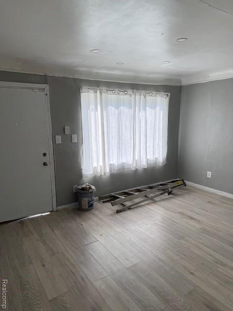19495 Lindsay St, Detroit, MI 48235 - unfurnished living room with healthy amount of natural light, wood finished floors, and baseboards
