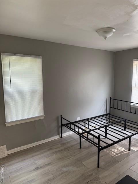 19495 Lindsay St, Detroit, MI 48235 - unfurnished bedroom featuring wood finished floors and baseboards