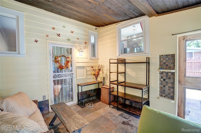 3418 Gratiot Ave, Flint, MI 48503 - living area with wooden ceiling, stone finish floors, and wood walls
