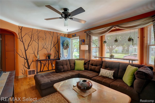 3418 Gratiot Ave, Flint, MI 48503 - living room featuring arched walkways, wood finished floors, plenty of natural light, and a ceiling fan