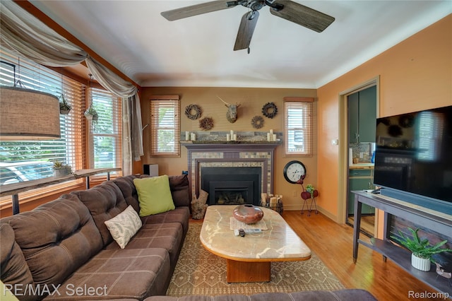 3418 Gratiot Ave, Flint, MI 48503 - living area featuring a tile fireplace, a ceiling fan, and light wood finished floors