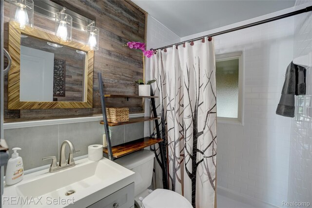 3418 Gratiot Ave, Flint, MI 48503 - bathroom featuring vanity, a shower with curtain, and wood walls