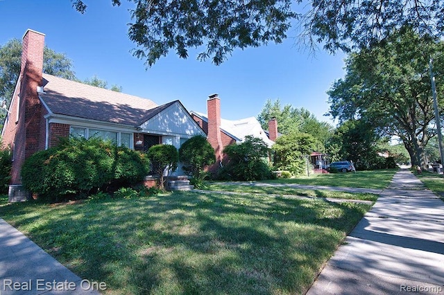 8035 Pinehurst St, Detroit, MI 48204 - view of property exterior with a lawn and a chimney